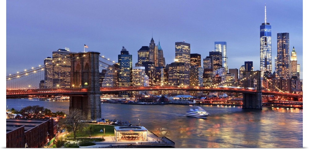 USA, New York City, East River, Manhattan, Brooklyn Bridge, Downtown skyline with the Freedom Tower illuminated at dusk, v...