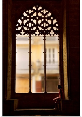 Spain, Valencia, Hall of Lonja de La Seda, Woman sitting by a window