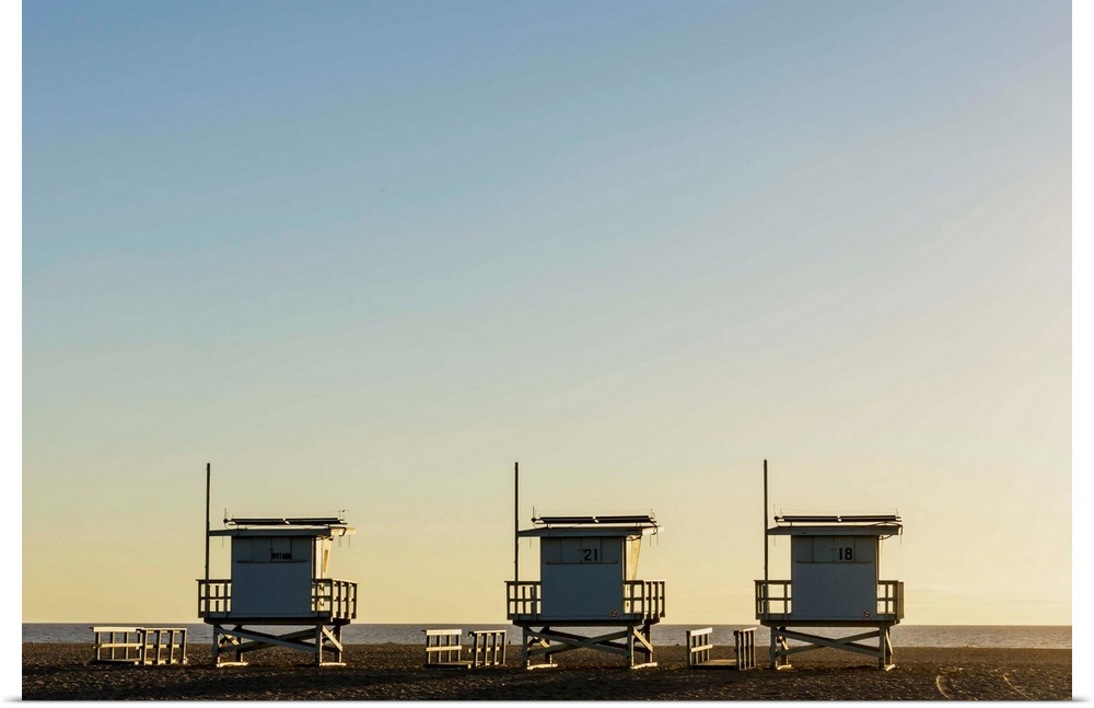USA, California, Los Angeles, Venice Beach, Lifeguard towers at sunset.
