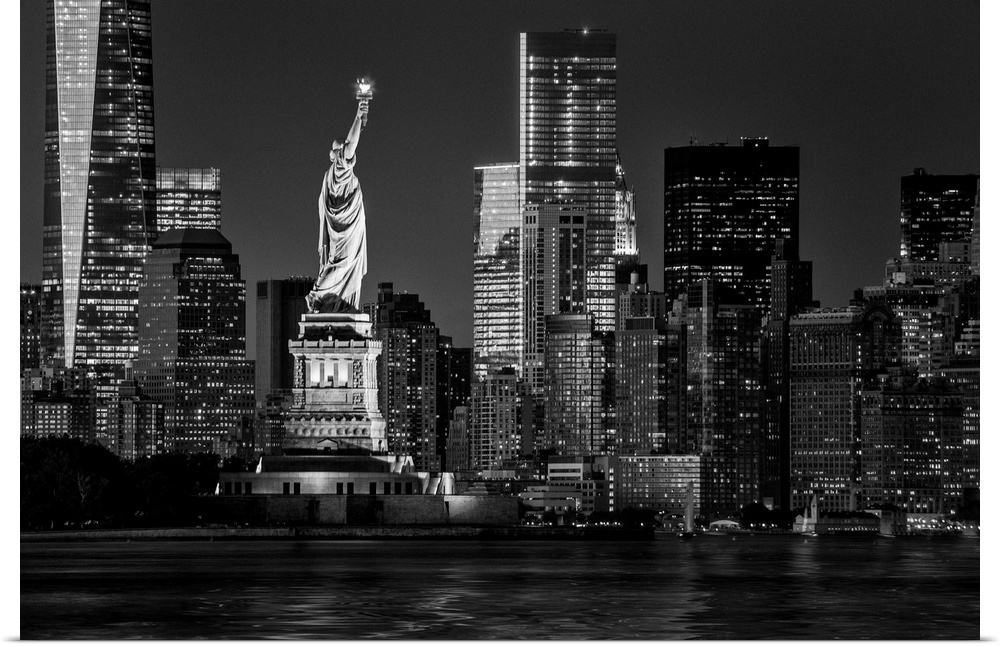 USA, New York City, Lower Manhattan, Lower Manhattan skyline and Statue of Liberty at night.