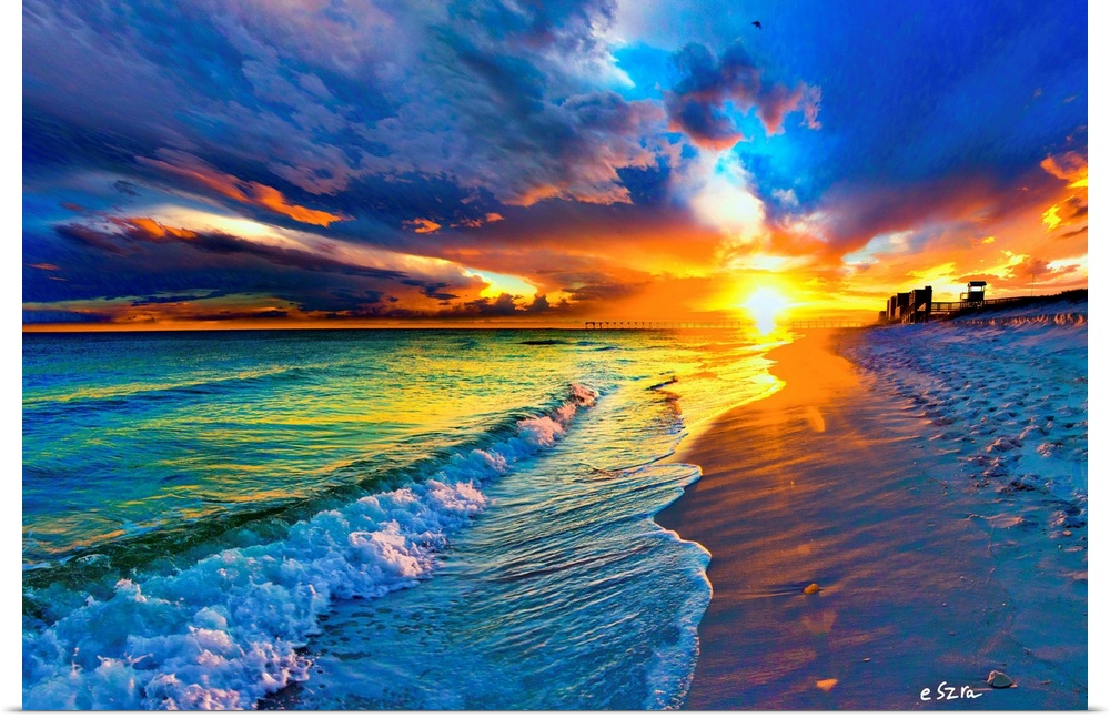 Blue sea under a yellow sun burst at sunset.