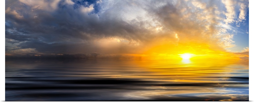 A beautiful golden panoramic sunset reflected in the ocean waves at sunset with bright spiraling white clouds.