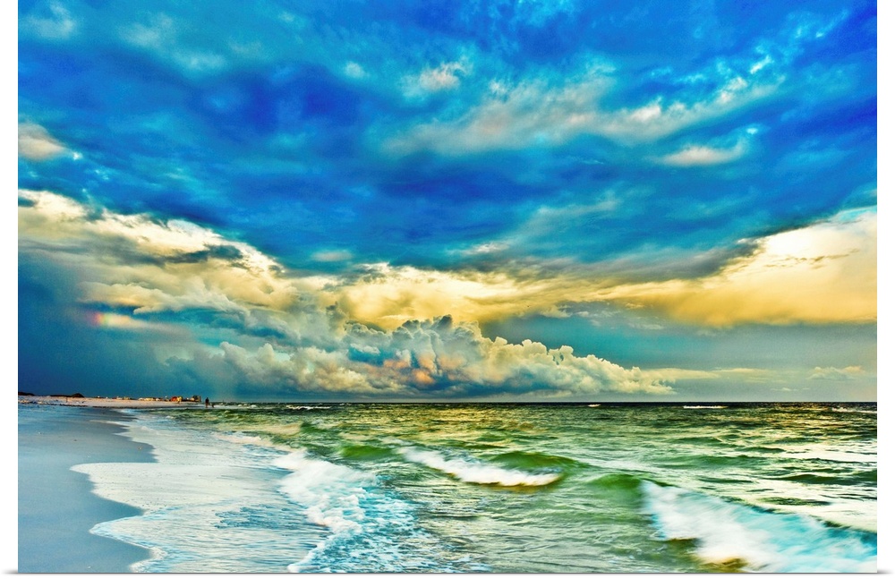 A blue and green painted looking seascape with blue clouds and waves breaking in emerald green waters. Landscape taken nea...