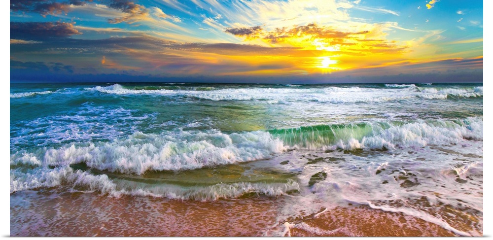 This panoramic beach sunset features breaking waves on a beautiful sea shore. A wave crashes on the shore before an orange...