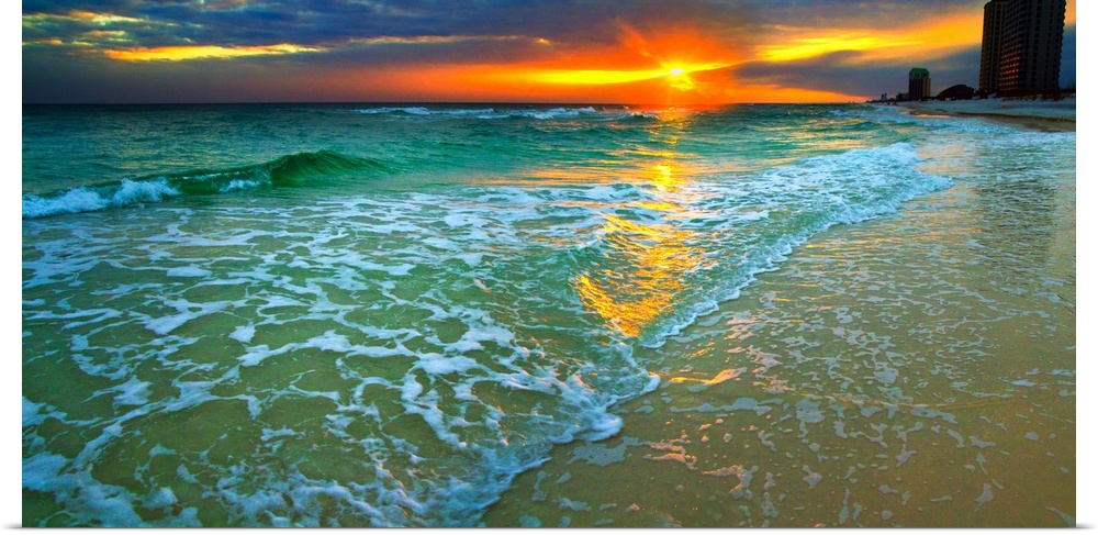 Emerald waves and soft white foam. Dark yellow and red sunset seascape. Landscape taken on Navarre Beach, Florida.