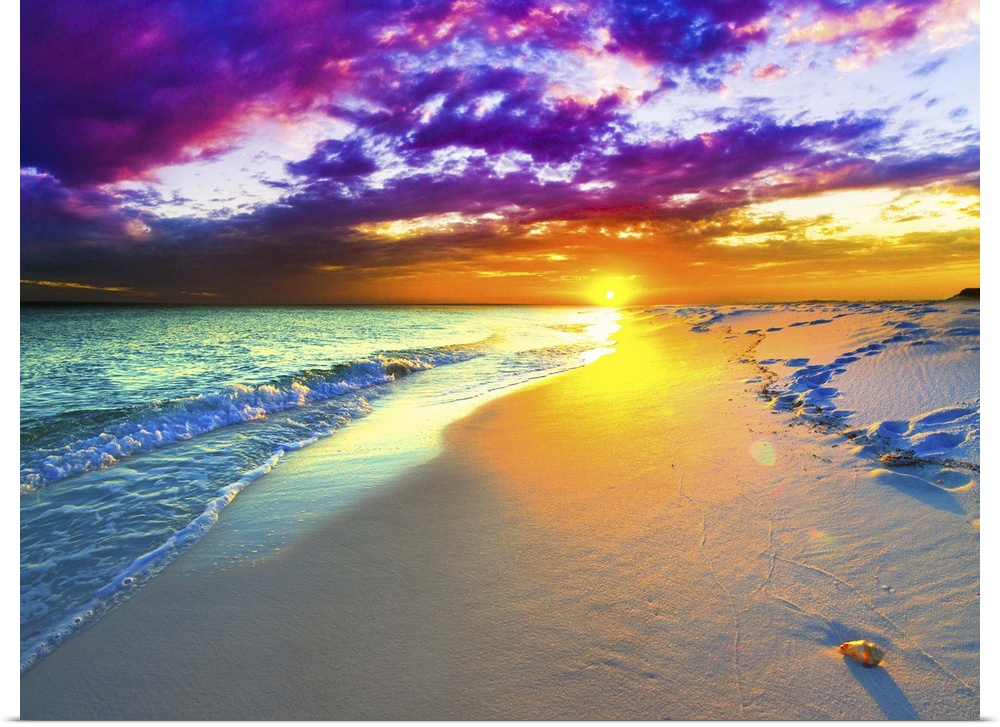 A beautiful purple and blue sunset over a sandy beach shoreline. The ocean takes up a small part of the beautiful picture.