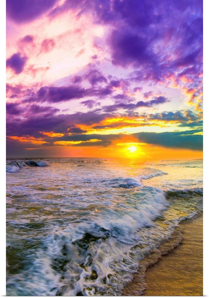 A pink and purple beach sunset over the ocean. The expansive vertical sky is excellent for a vertical sunset image.