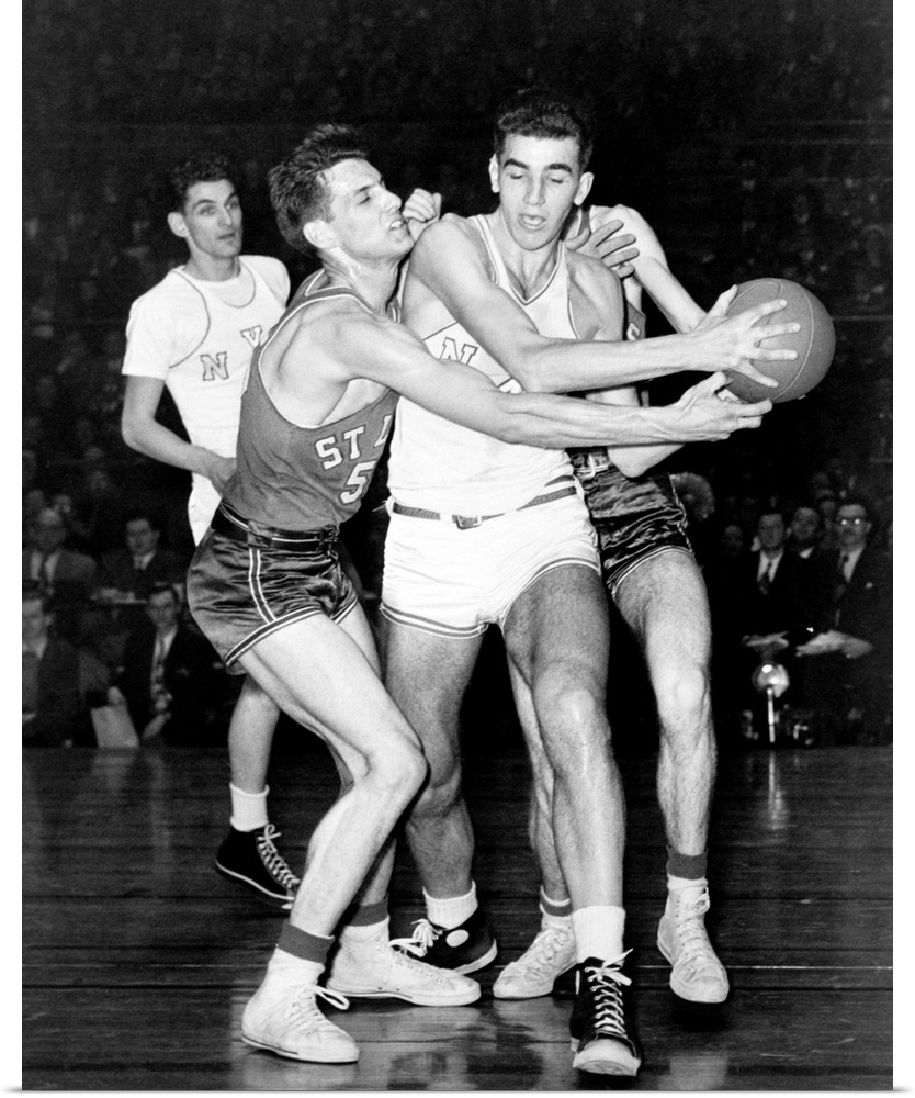 Adolph 'Dolph' Schayes keeping the basketball away from Joe Ossola of St. Louis University, 1948. Schayes, playing for New...
