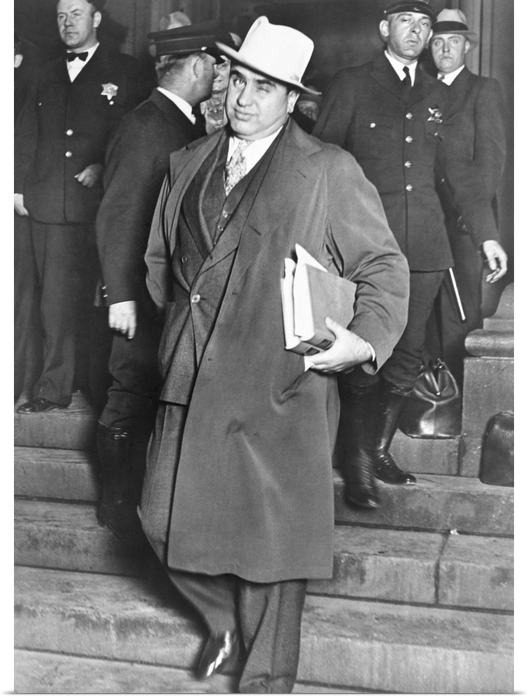 Al Capone, winks at photographers as he leaves Chicago's federal courthouse. October 14, 1931. The notorious Chicago gangs...