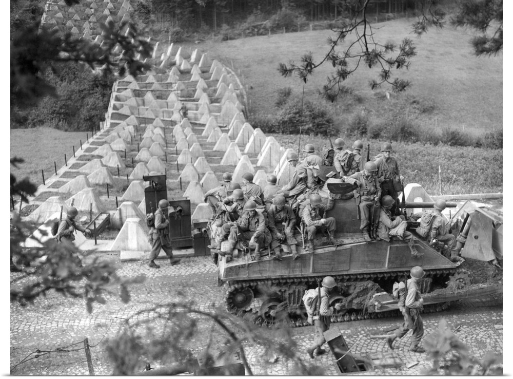 Americans roll through Siegfried Line on a 'tank dozer' near Roetgen, Germany, on Sept. 28, 1944. Roetgen was the first Ge...