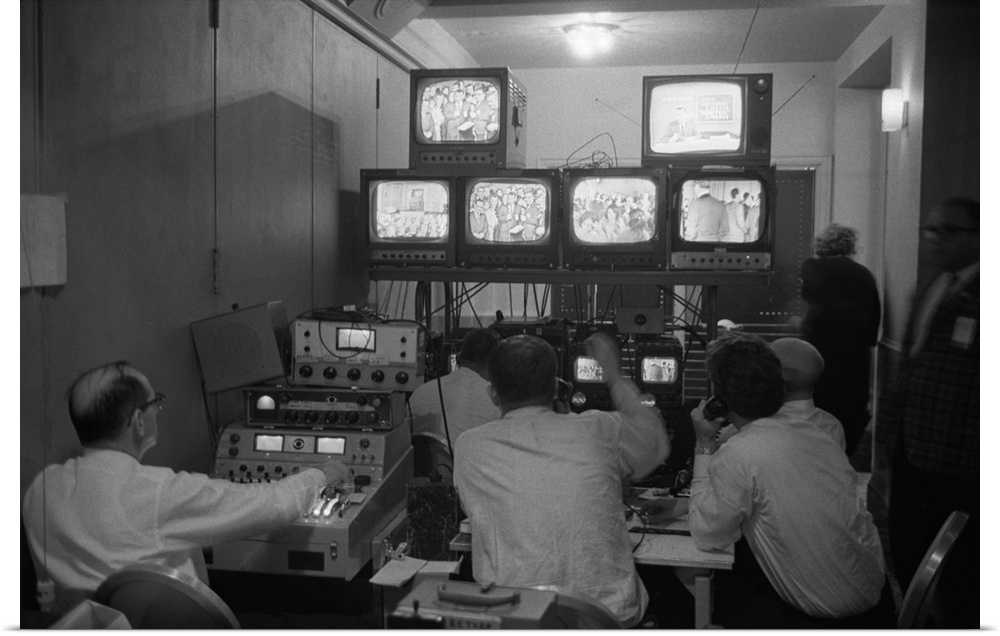 Broadcasting technicians, seated in front of bank of television sets at the Democratic Headquarters. Election Night, Novem...