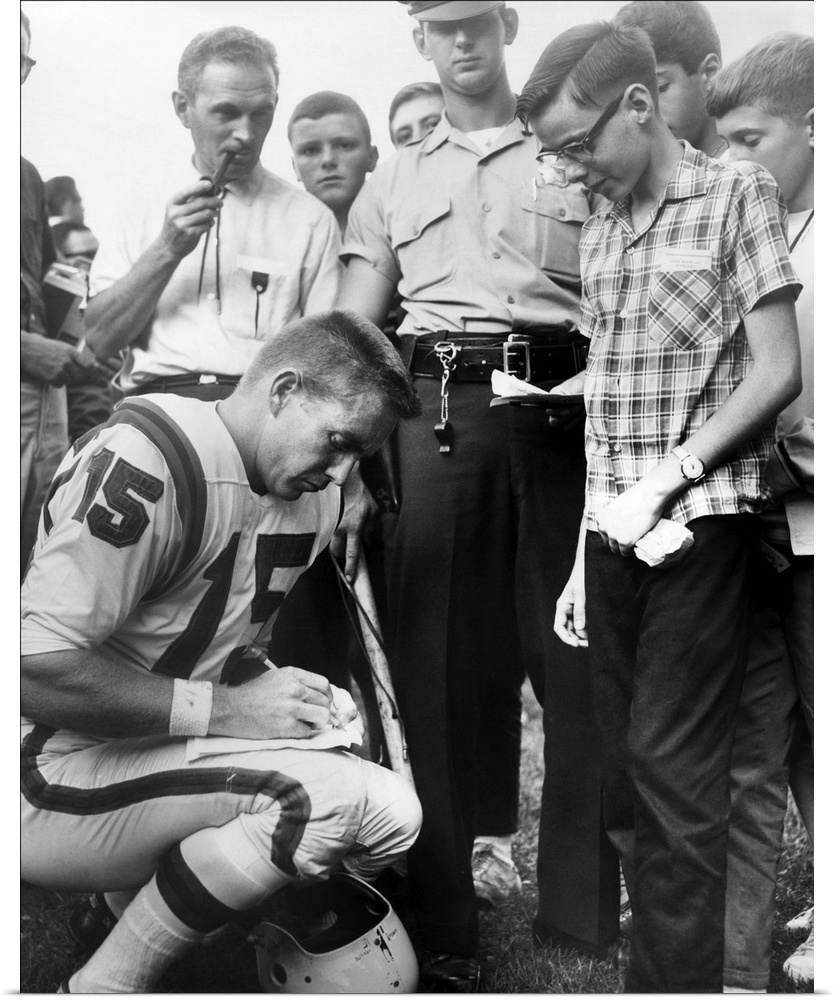 Buffalo Bills player Jack Kemp signs his autograph for a boy on August 4, 1964. Kemp played professional football from 195...