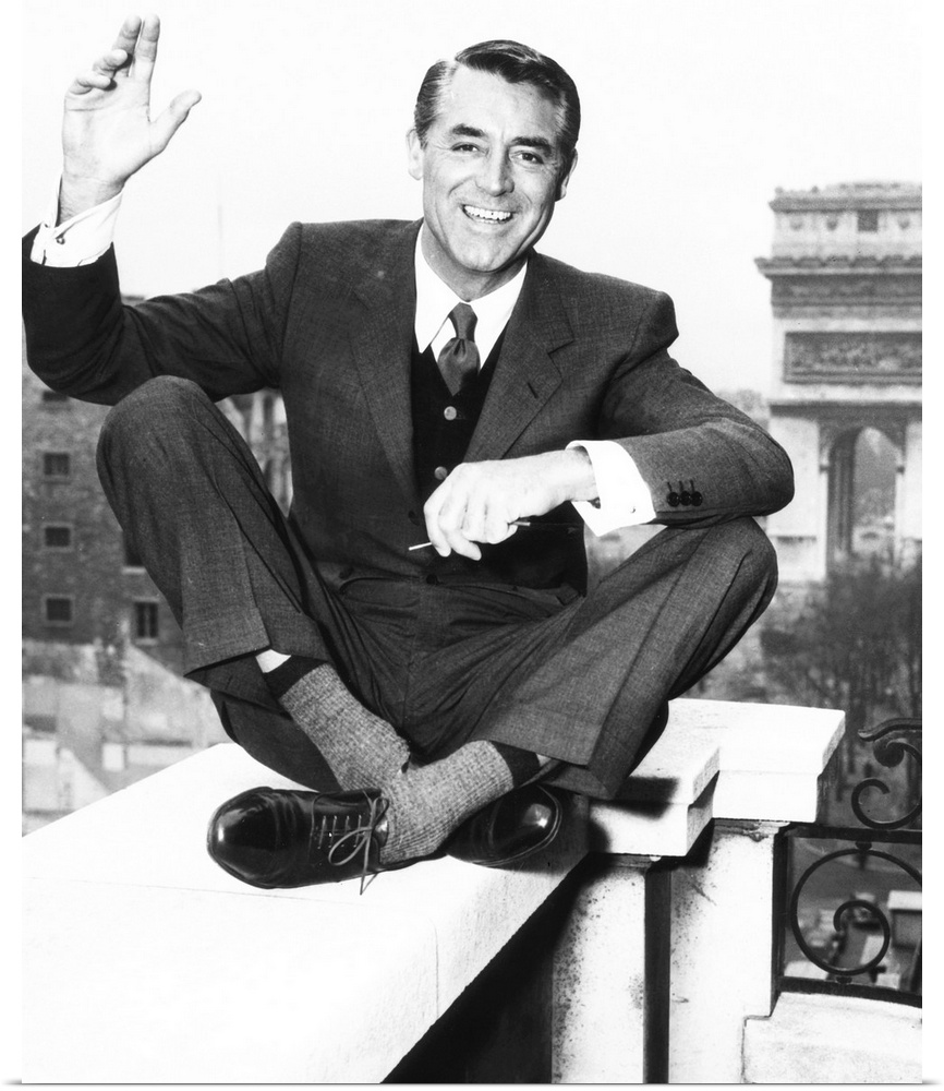 Cary Grant on the balcony of his Paris hotel room overlooking the Arc de Triomphe, 1956.