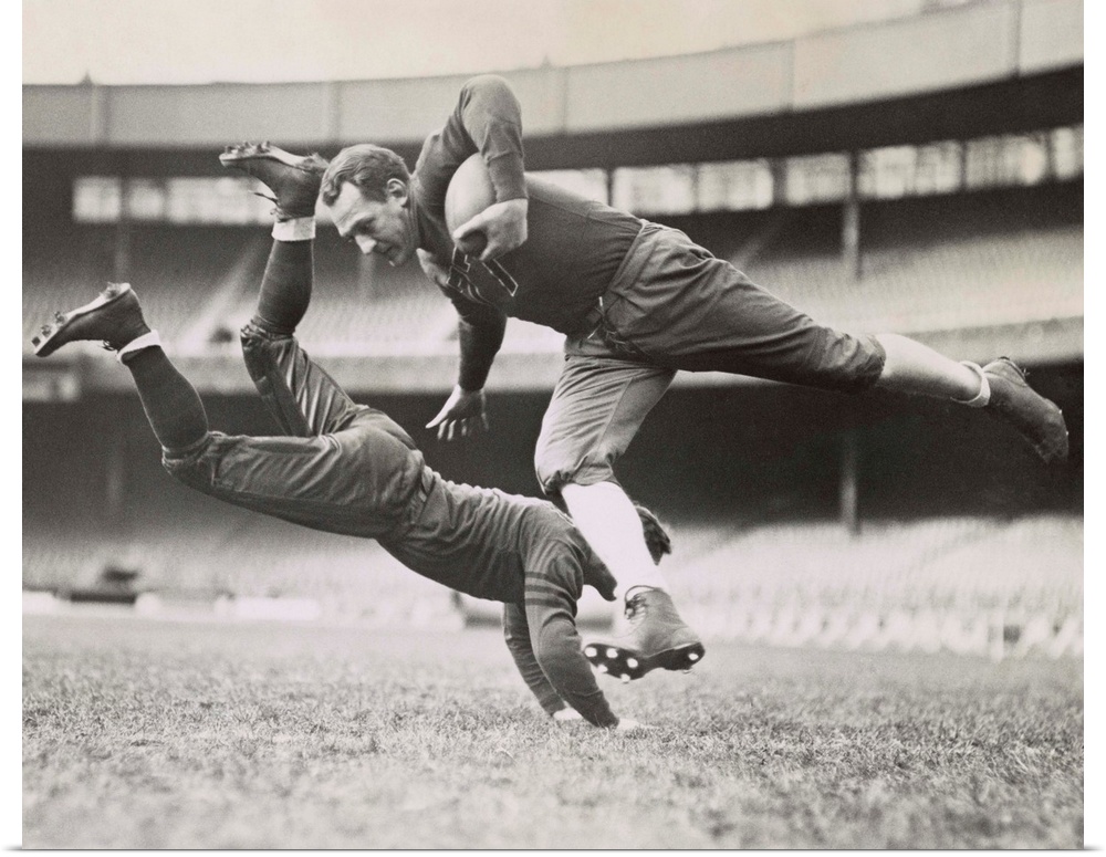 Chicago Bears teammates practicing as Joe Zeller tries to tackle Red Grange. March 18, 1935.