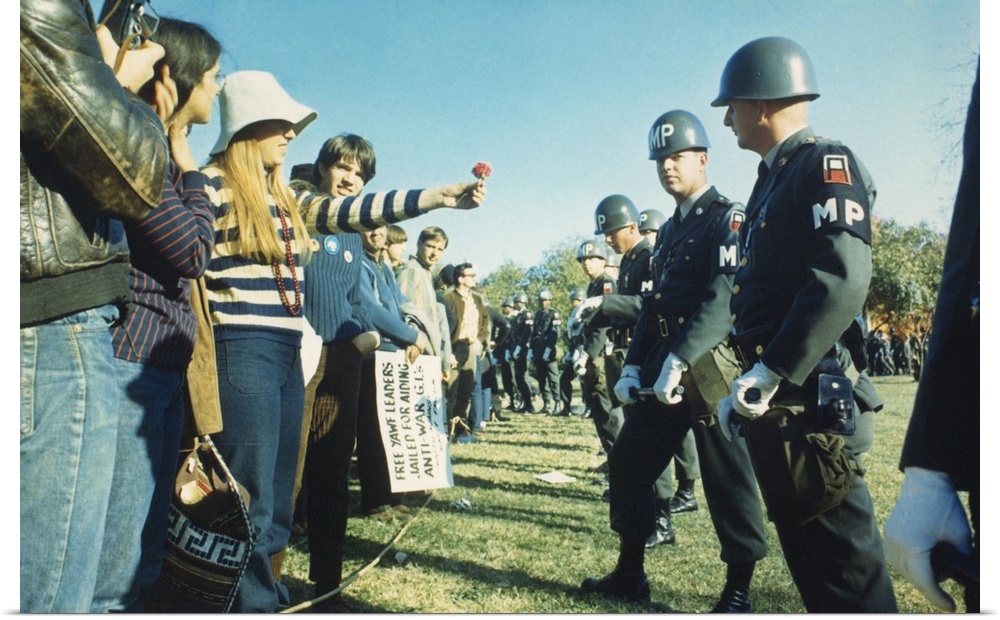 Female demonstrator offers a flower to military police during the 1967 March on the Pentagon. 50,000 Anti-Vietnam War demo...