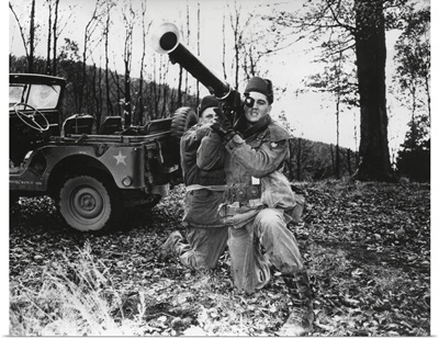 Elvis Presley training with a bazooka while on maneuvers in Germany