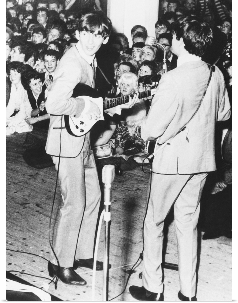 George Harrison and Paul McCartney, of the Beatles perform in Manchester, England. Nov. 11, 1963. The original caption of ...