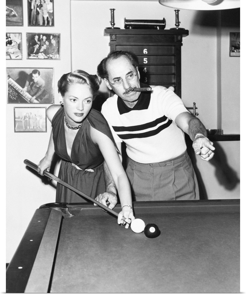 Groucho Marx at home playing billiards with his young wife, Actress Kay Maris in 1949. Her first husband was Actor Leo Gor...