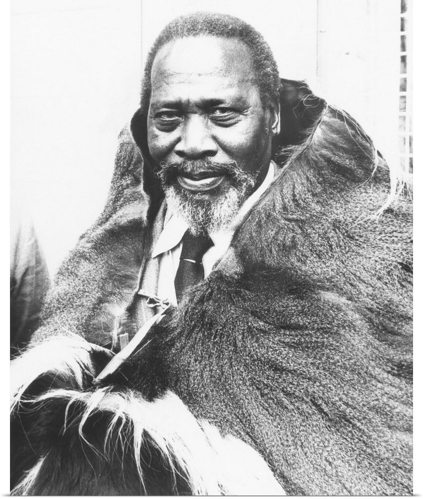 Jomo Kenyatta, future President of Kenya, in a monkey skin given him by Kikuyu (Gikuyu) tribesmen. Aug. 21, 1961. Kikuyu w...