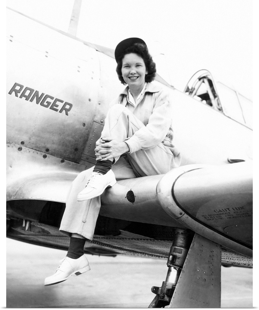 Margaret (Mickey) McGrath, former WASP sitting on the wing of in an XAT-6E trainer aircraft. It was equipped with an exper...