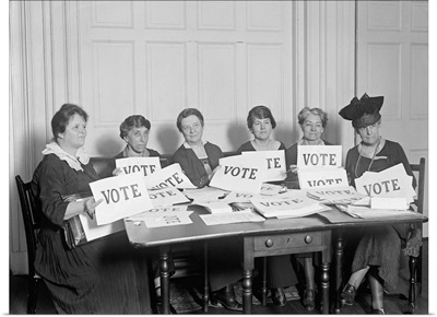 National League of Women Voters hold up signs reading, 'VOTE'