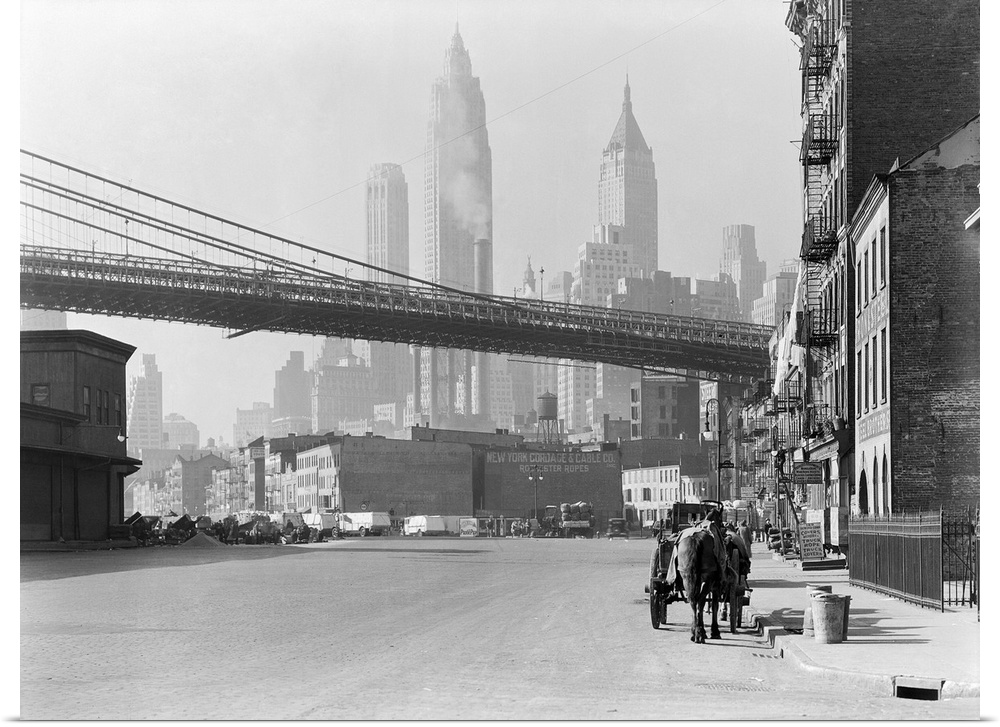 New Your City's South Street, Nov. 28, 1933. The Brooklyn Bridge spans over the street, with the skyscrapers of the Financ...