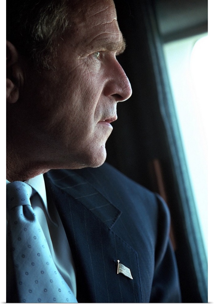 President George W. Bush surveys the damage to the Pentagon from Marine One, Sept. 14, 2001. Three days after the 9-11 Ter...