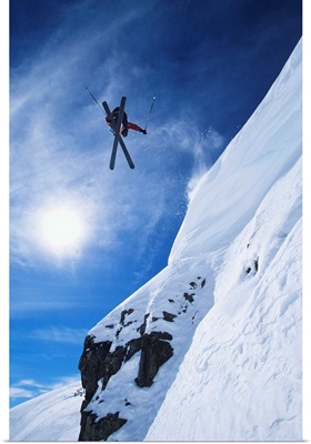 Skier Jumping From Mountain Ledge