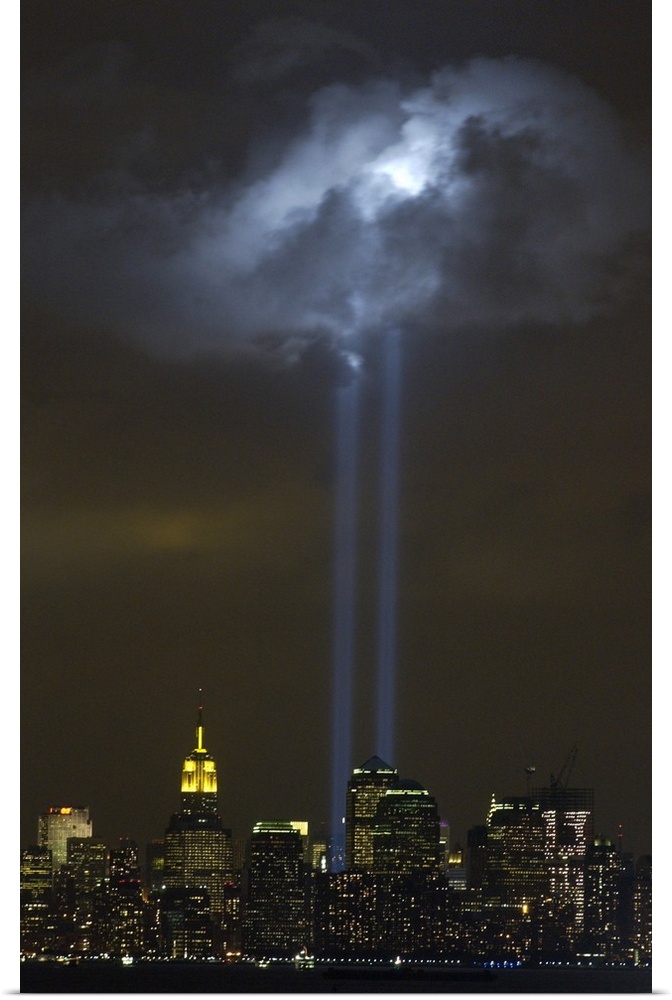 Tribute in Light Memorial illuminates a passing cloud above lower Manhattan. Sept. 9, 2004. The twin towers of light, made...