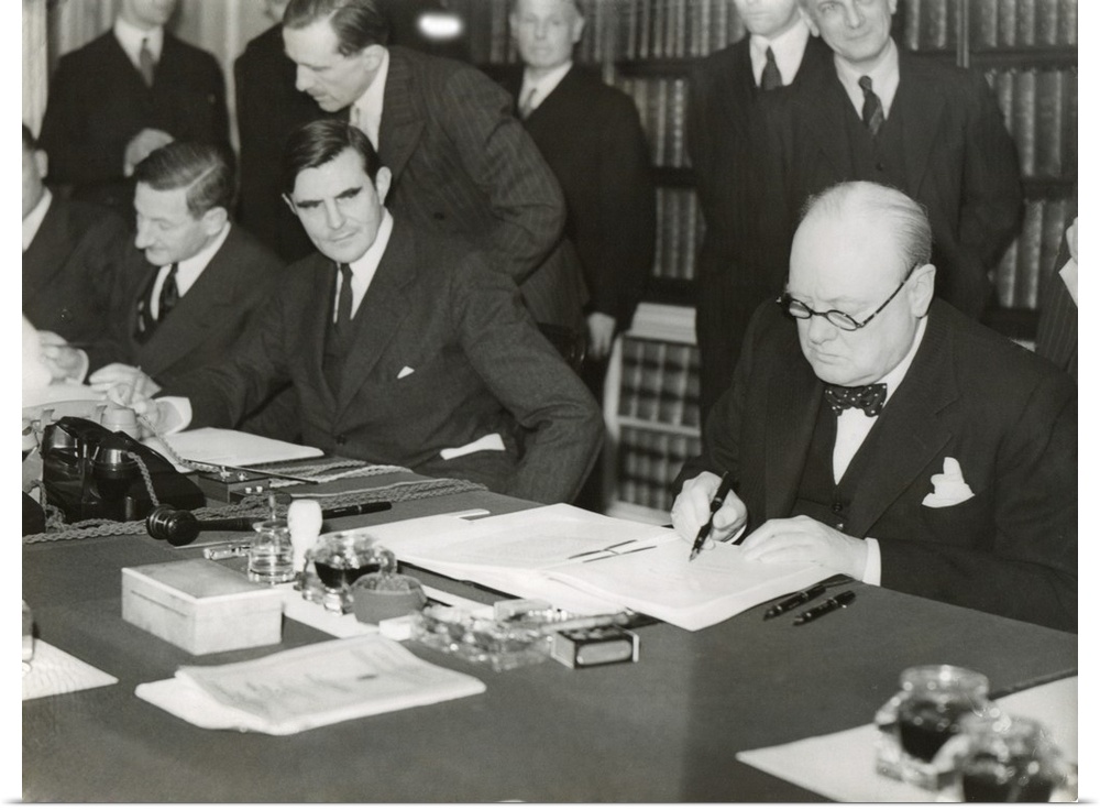Winston Churchill signing the 'Lend Lease' agreement to lease British bases to the U.S. March 11, 1941. From his desk at 1...