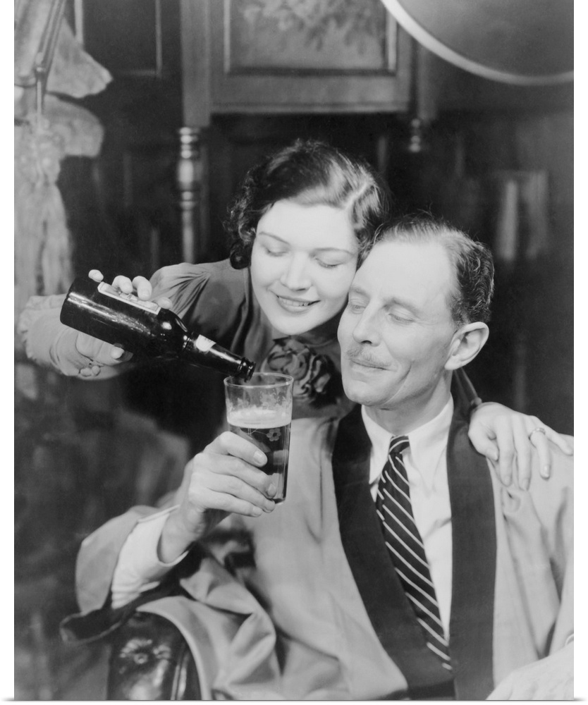 Young woman pouring beer into a man's glass, 1933. Photo was created in response to the legalization of beer with an alcoh...