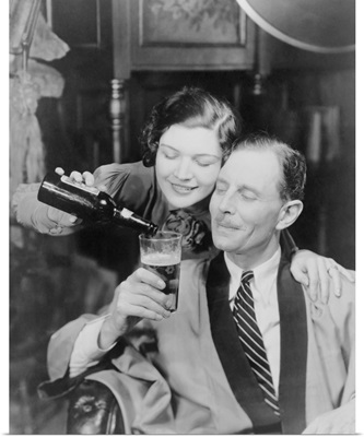 Young woman pouring beer into a man's glass, 1933