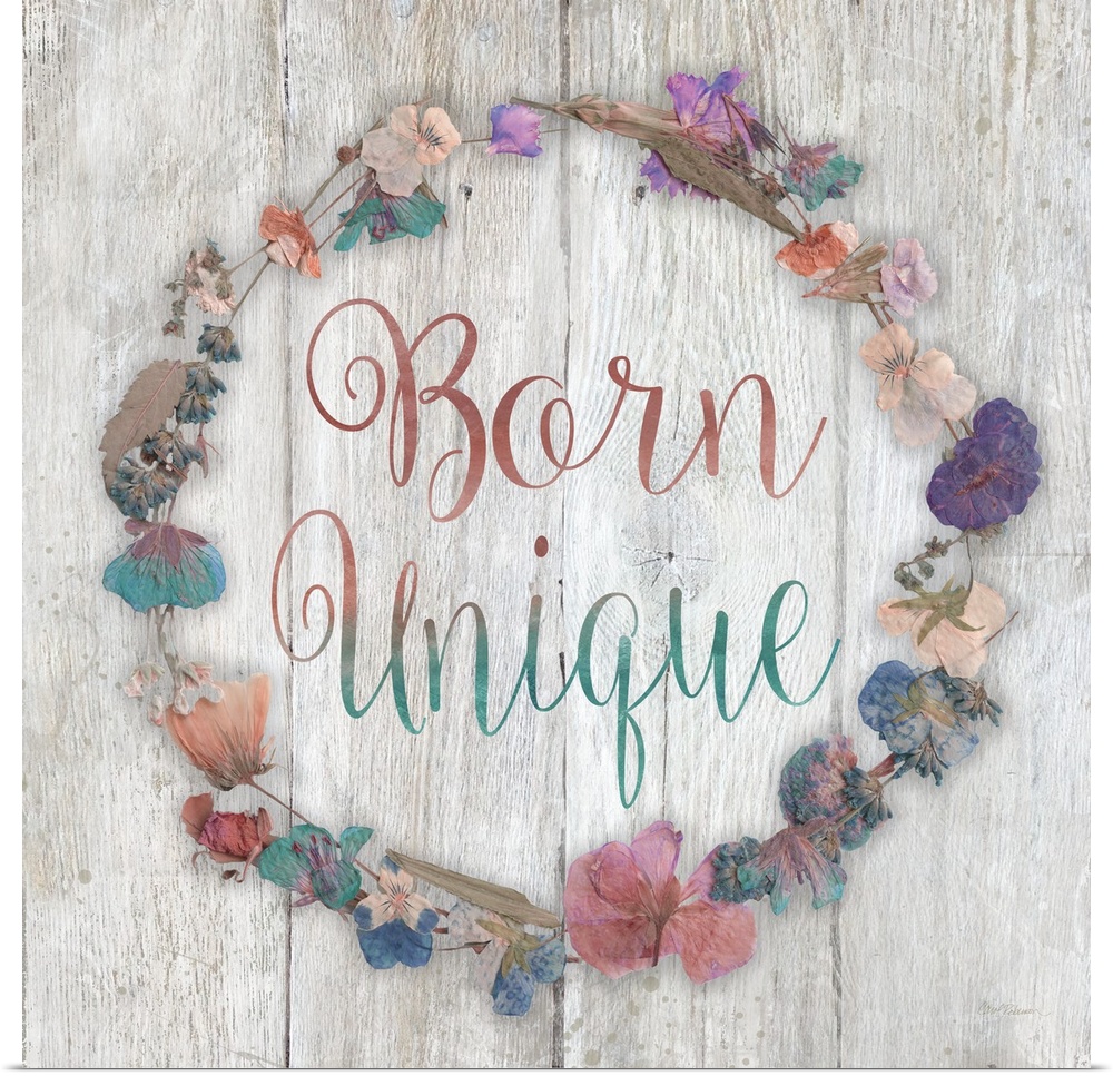 "Born Unique" placed on a white washed wood texture with dried flowers surrounding it.