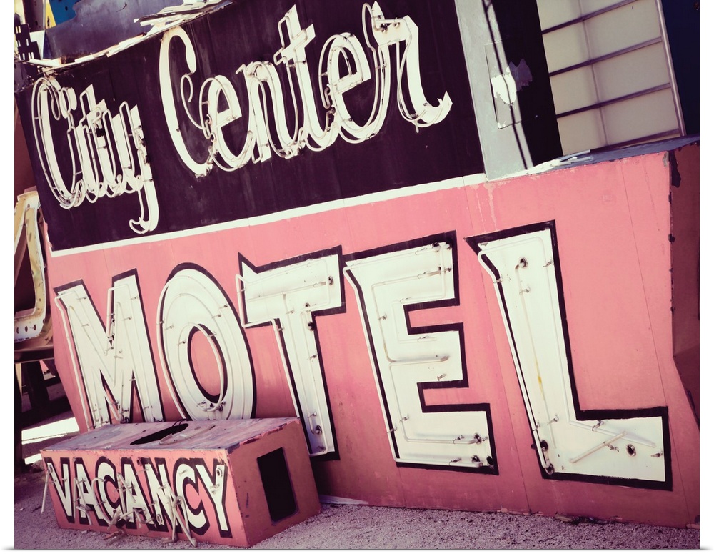 Photograph of a pink and maroon vintage City Center Motel sign from a unique angle.
