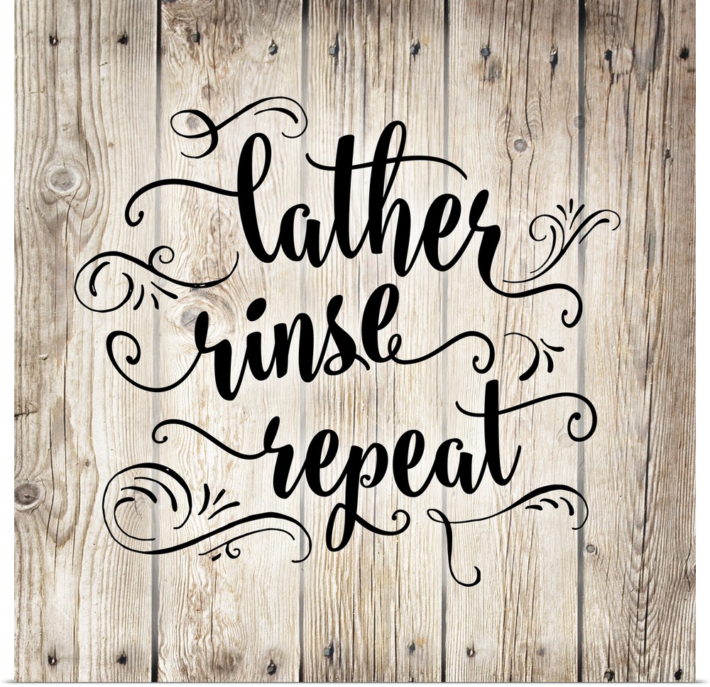 The words "Lather, rinse, repeat" is arranged on this square light wood design with decorated embellishments around the text.