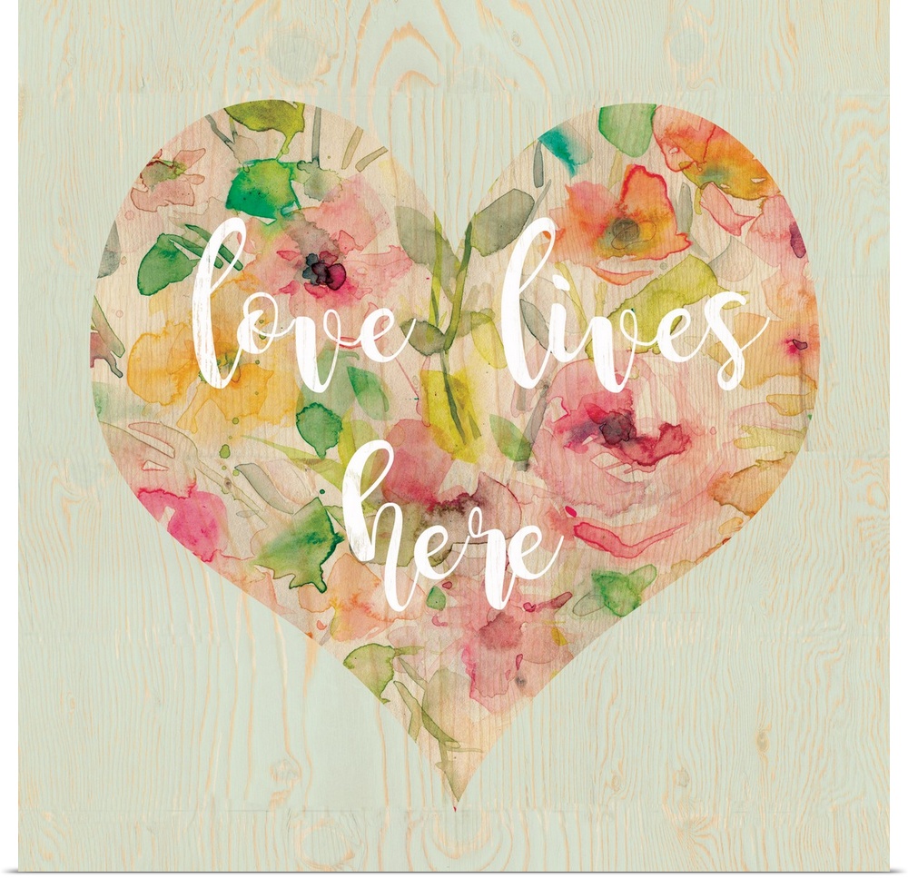 "Love Lives Here" written in white script inside a heart filled with watercolor flowers, all on a square faux wood backgro...