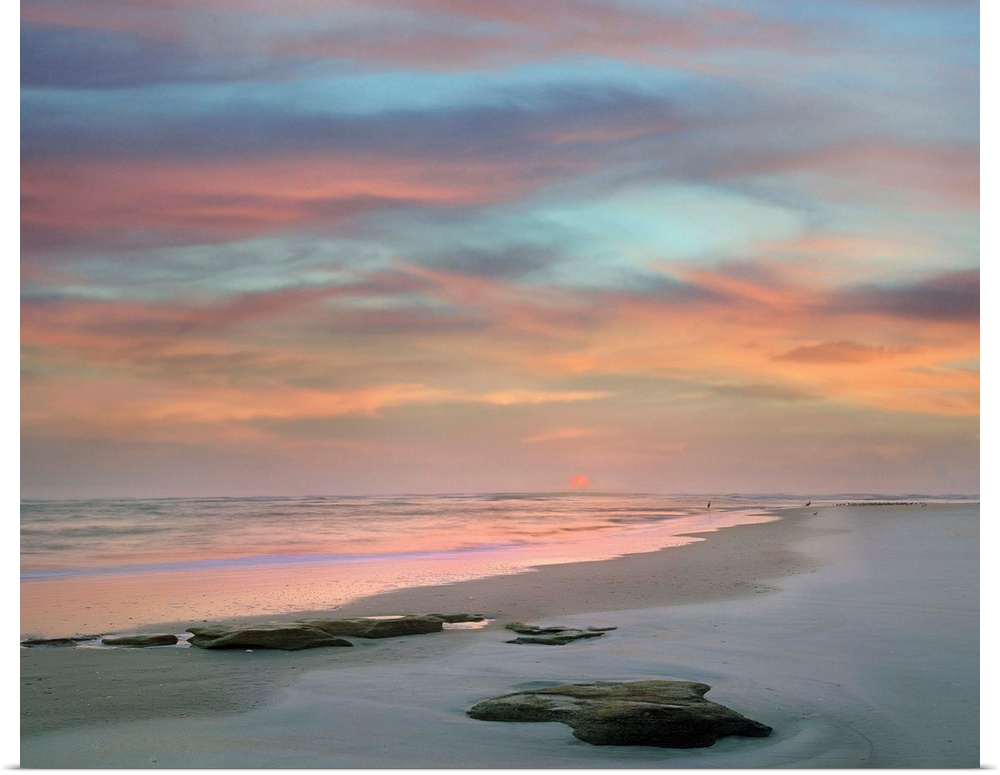 Landscape photograph of a colorful sunset on Matanzas Beach, FL.