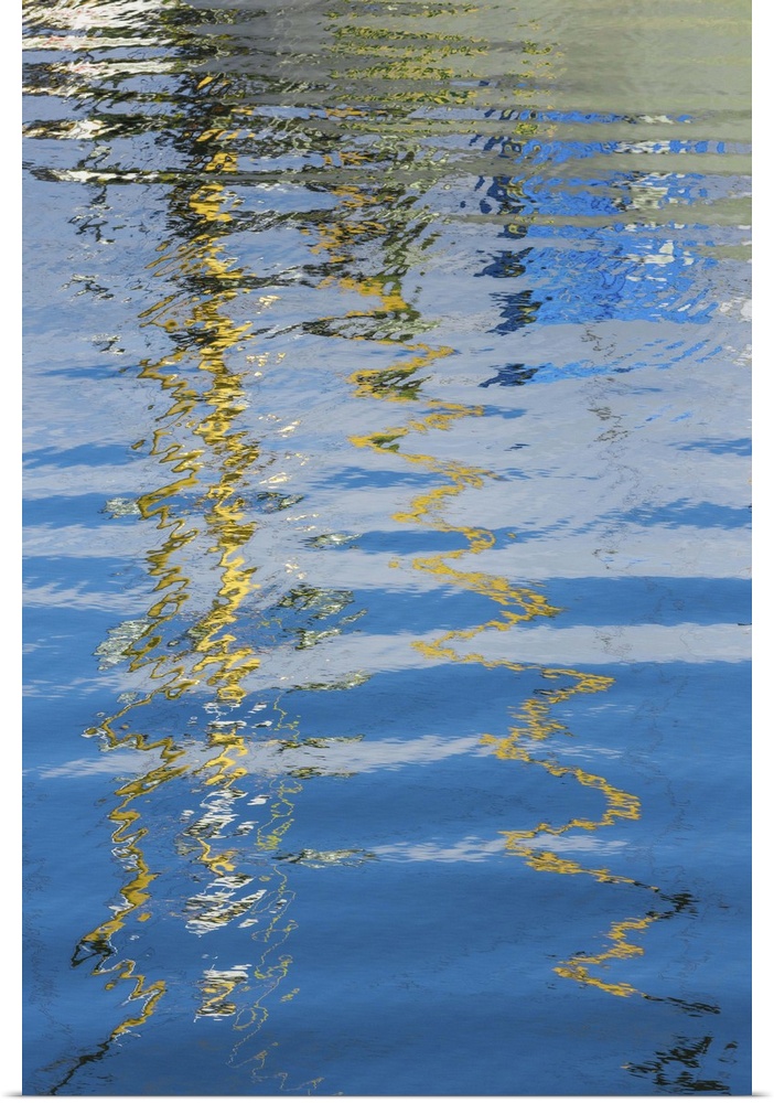 Reflection of a boat on rippling water, creating an abstract image.