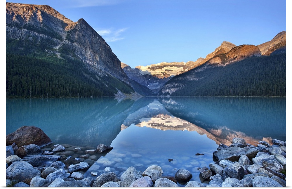 Early morning with rocky foreground on Lake Louise in Banff National Park