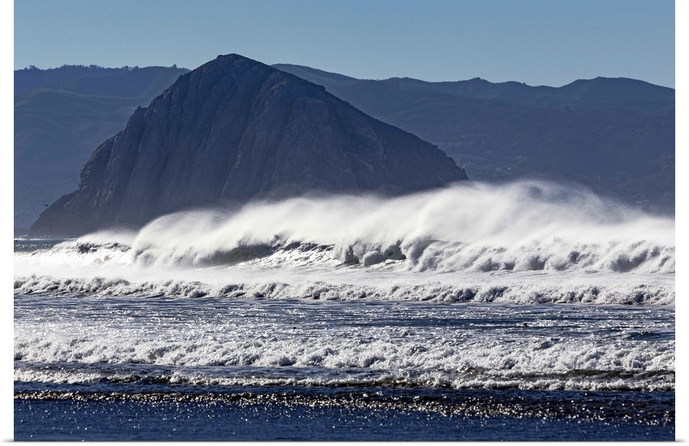 Photograph of big dramatic surf crashing over rocks in Morro Bay, California.