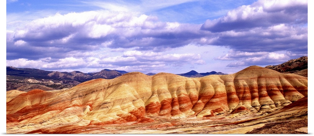 Large white clouds over the Painted Hills in Oregon.