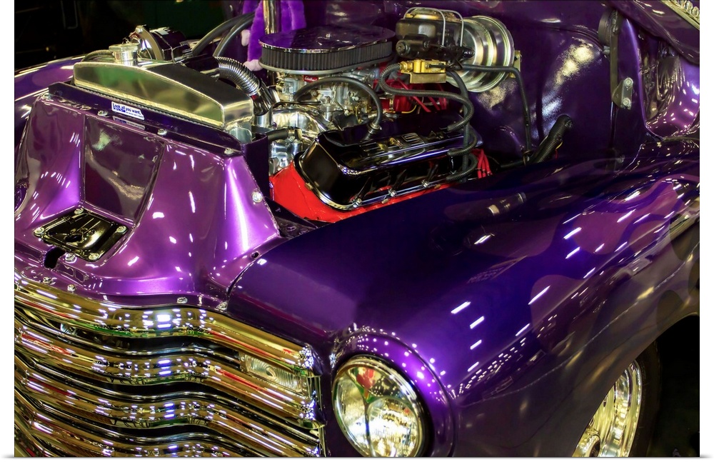 Fine art photograph of a vintage car. The engine is visible and the paint job is a stunning purple.
