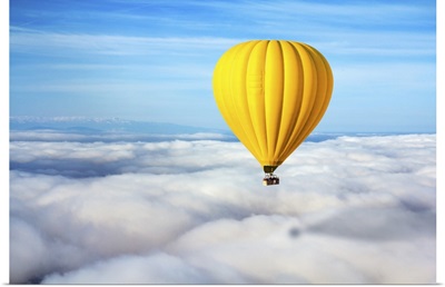A Lonely Yellow Hot Air Balloon Floats Above The Clouds