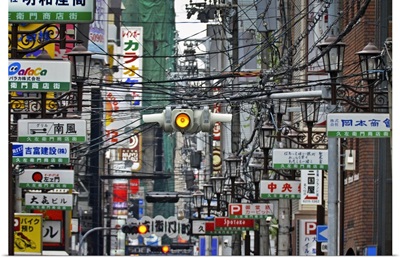 Amerikamura district, with chaos of street signs, lights, advertising and wires.