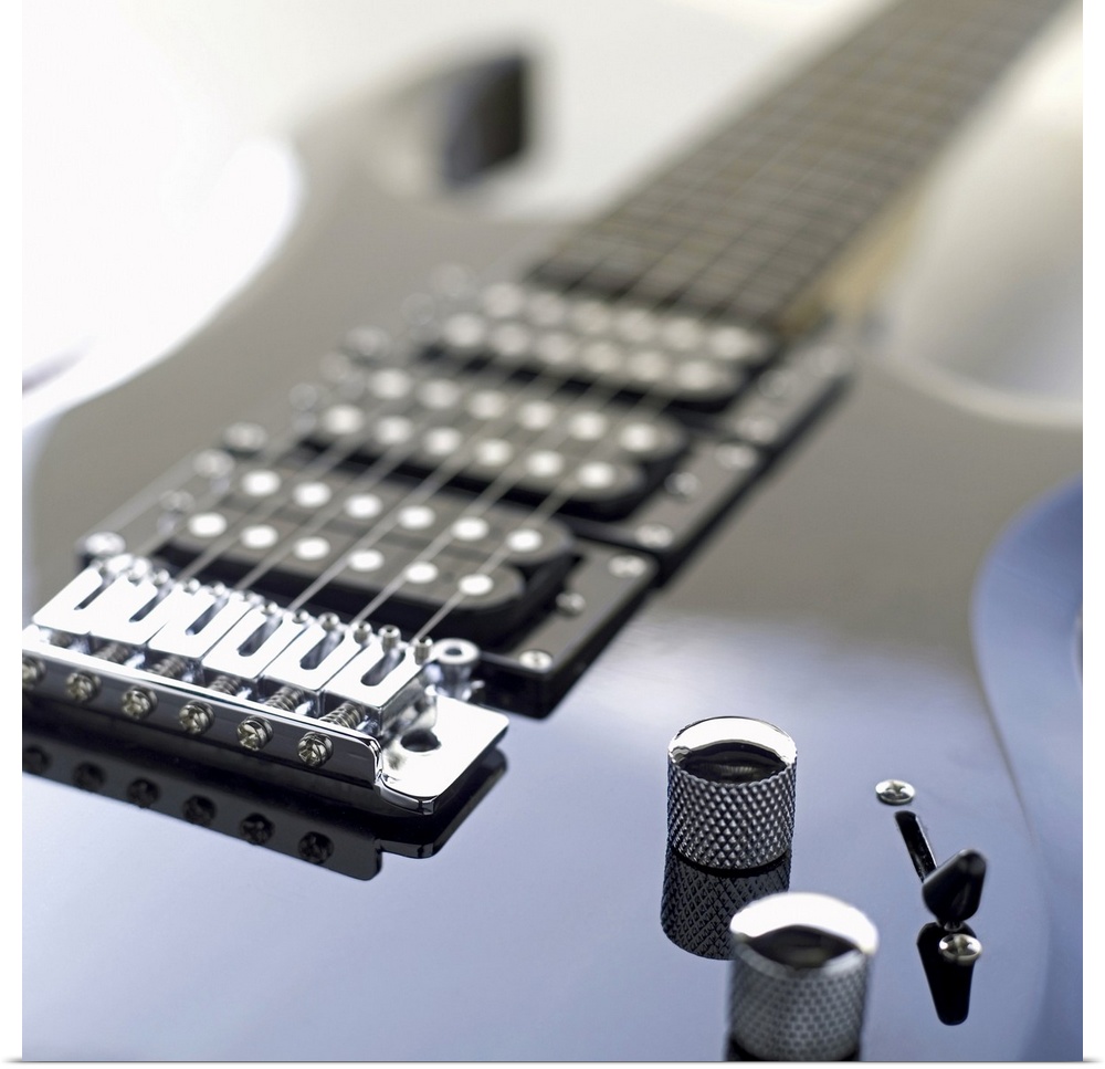 Square photograph of a close-up of an electric guitar.