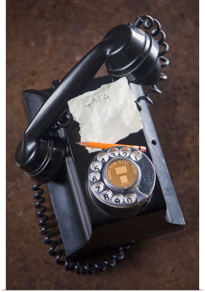 antique telephone with a piece of paper and pencil