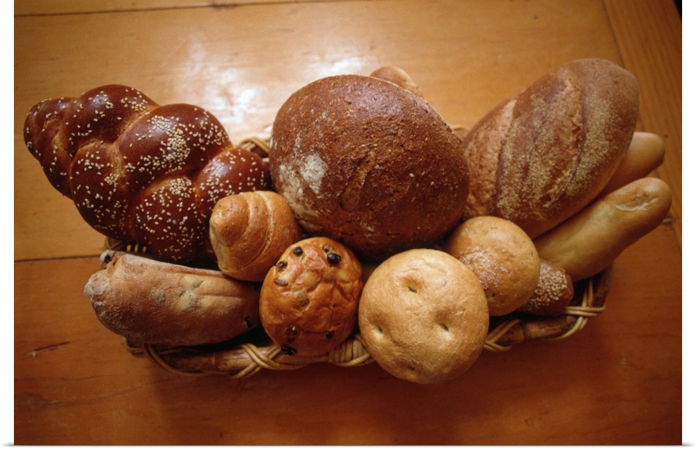 Different types of bread are placed together in a long basket.