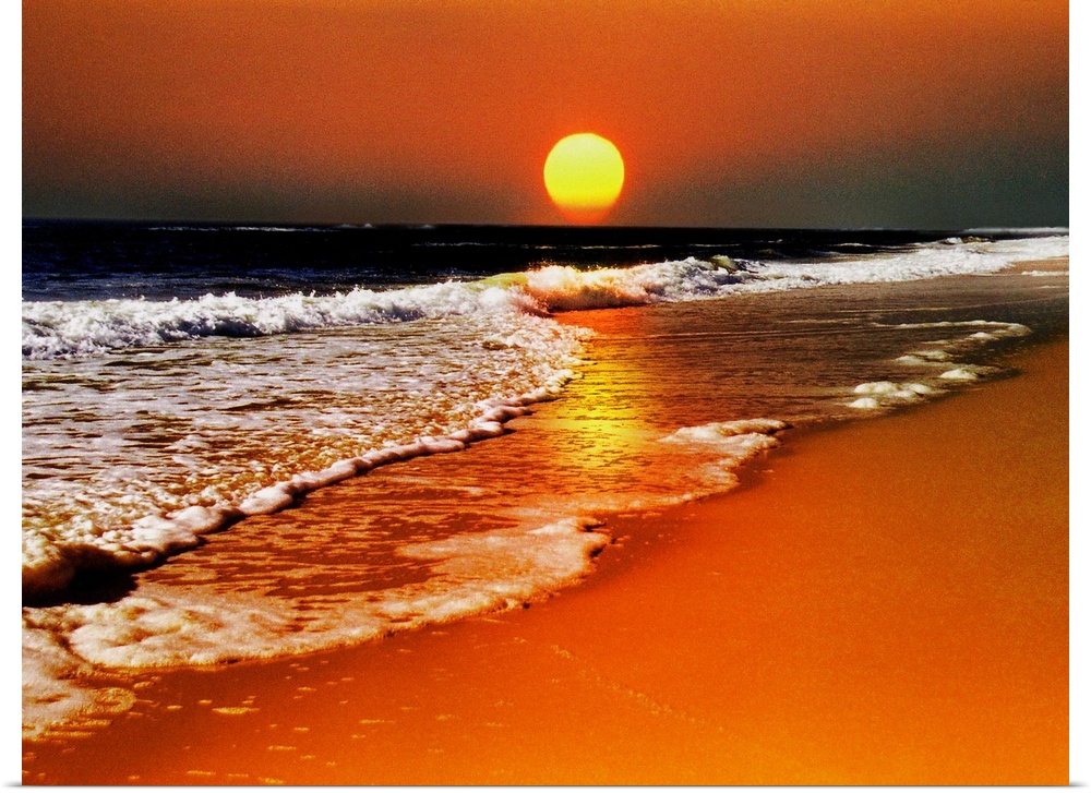This canvas wall art is a photograph of the sun dropping below the horizon in this landscape at the sea.