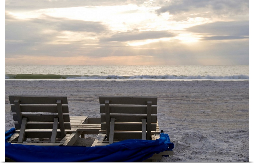 Beach chairs on St. Pete's beach at sunset.