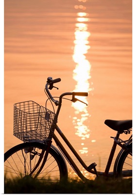 Bicycle in sunshine beside water. Otsu, Shiga Prefecture, Japan